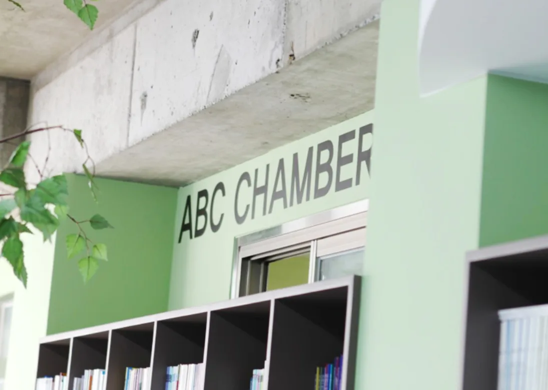 The ABC Chamber reading room with green walls and bookshelves