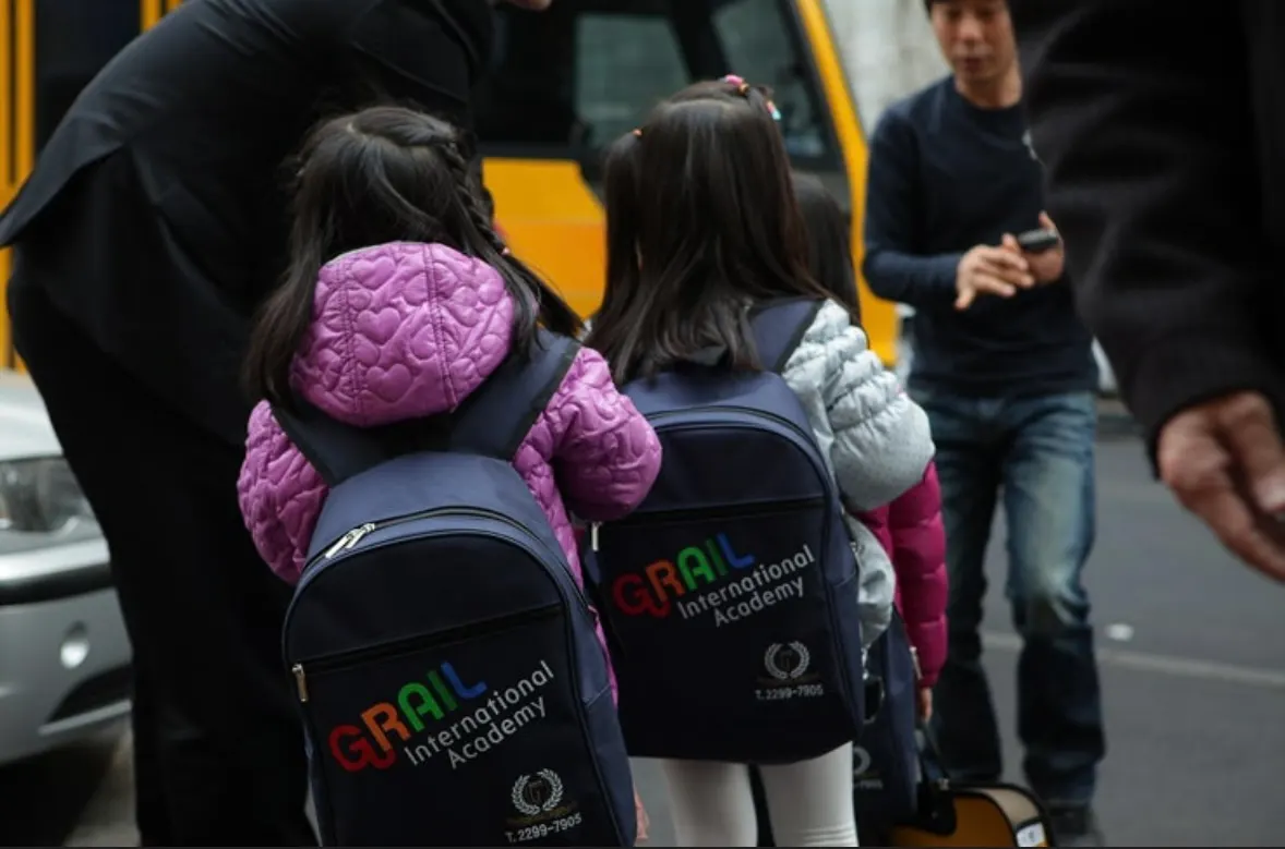 Children wearing GRAIL International Academy backpacks