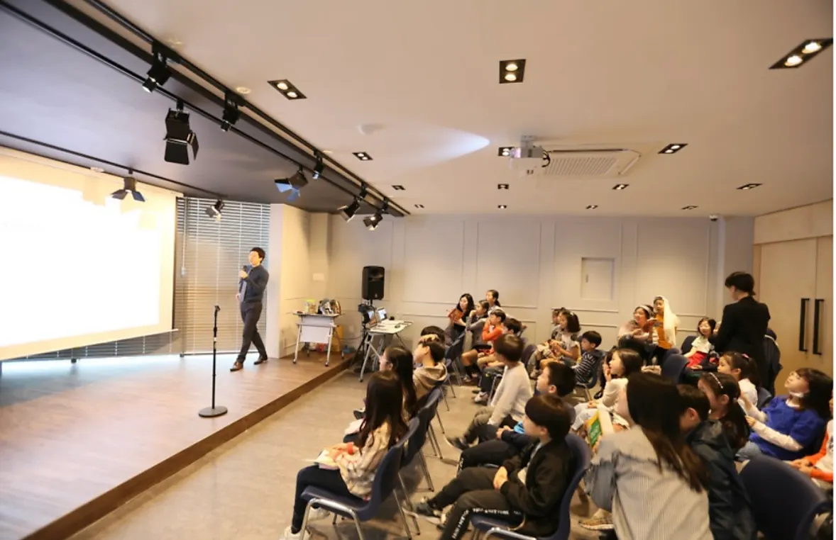 The GRAIL event hall with a stage, lighting and seated students