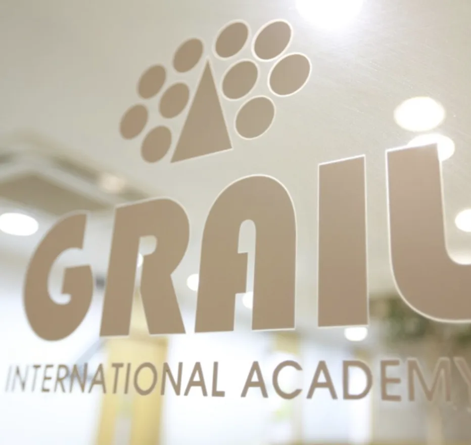 The GRAIL International Academy logo on the academy's glass door