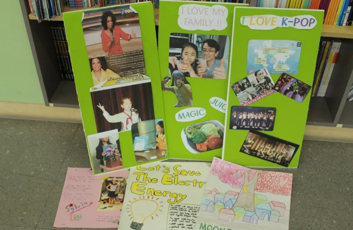 Student project posters titled I love my family, I love K-pop and Let's save the electric energy