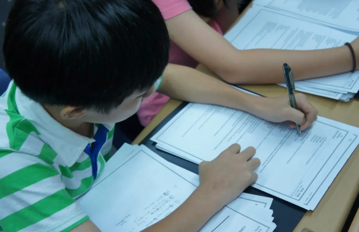 A student writing answers on a GRAIL test paper